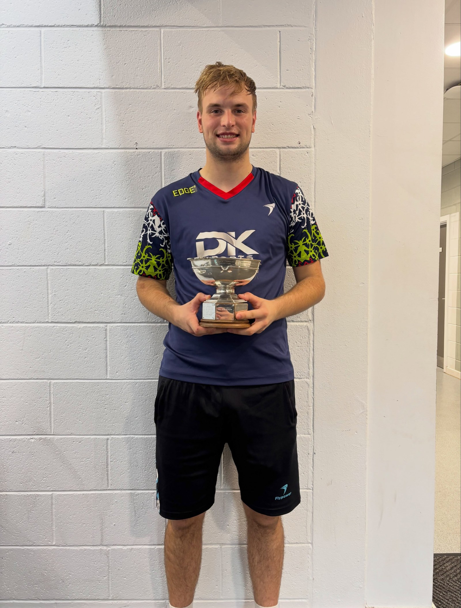 Head coach Luke Hoult with his Leicestershire county championship trophy